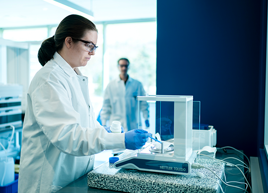 Researcher conducting analysis in analytical and material sciences lab Researcher conducting analysis in analytical and material sciences lab