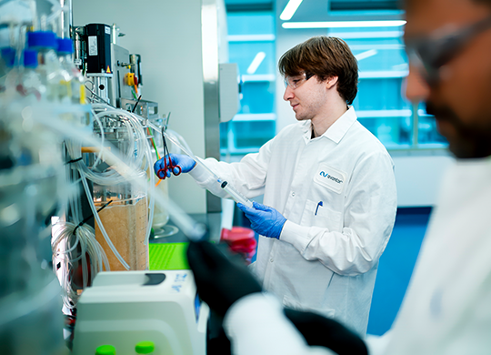 Technicians working in ligand bioengineering lab. Technicians working in ligand bioengineering lab.