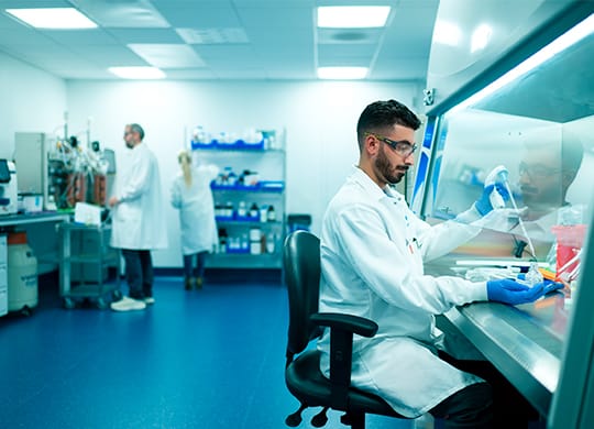 Researcher preparing sample in cell and gene therapy labs Researcher preparing sample in cell and gene therapy labs