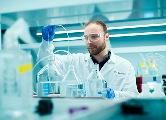 Researcher prepping analysis in downstream development lab Researcher prepping analysis in downstream development lab