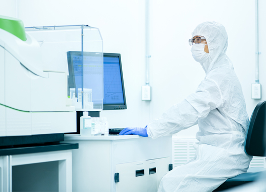 Technician in cleanroom using advanced biologic analytical tools Technician in cleanroom using advanced biologic analytical tools